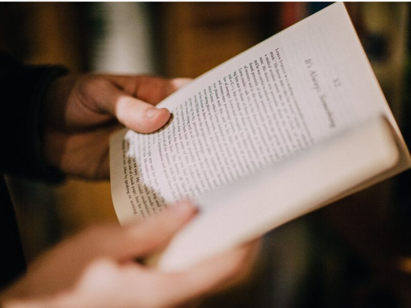 Hands holding an open book – Melbourne technical writer and accredited editor providing clear, accurate documents, manuals, and proofreading services.