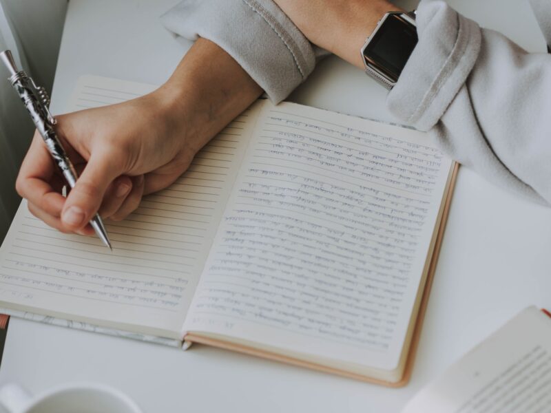 Editor writing notes in a notebook – Melbourne accredited editor and proofreader offering professional editing services, technical writing, and content design.